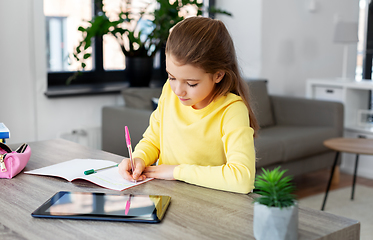 Image showing student girl writing to notebook at home