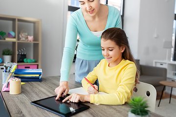 Image showing mother and daughter with tablet pc doing homework