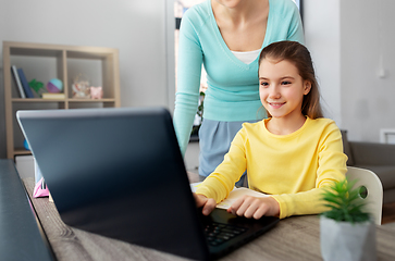 Image showing mother and daughter with laptop doing homework