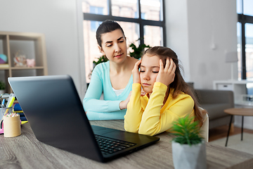 Image showing mother and daughter with laptop doing homework