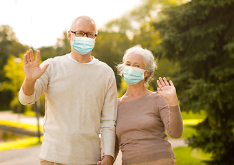 Image showing senior couple in protective medical masks at park