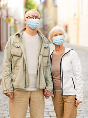 Image showing senior couple in protective medical masks in city