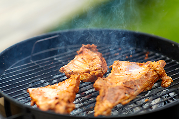 Image showing close up of barbecue meat roasting on grill