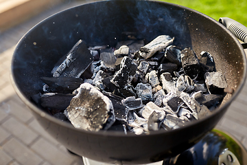 Image showing charcoal smoldering in brazier outdoors