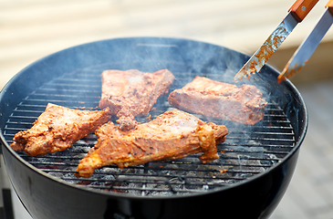 Image showing close up of barbecue meat roasting on grill