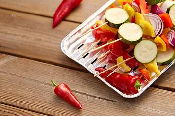 Image showing close up of vegetables on skewers on foil grill