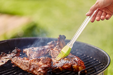 Image showing close up of barbecue meat roasting on grill