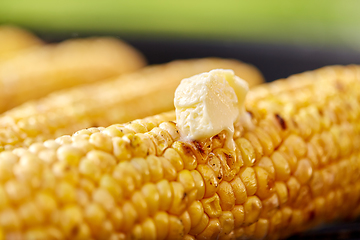 Image showing close up of corn with butter roasting on grill