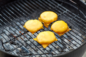 Image showing close up of meat cutlet with cheese on grill