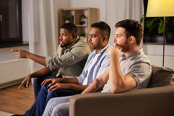 Image showing male friends watching tv and talking at home