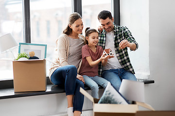 Image showing happy family with house model moving to new home