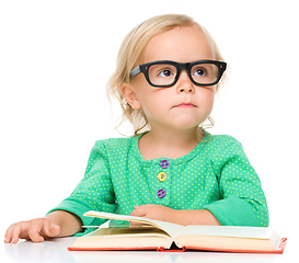 Image showing Little girl is reading her book