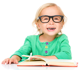 Image showing Little girl is reading her book