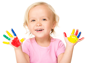 Image showing Portrait of a cute little girl playing with paints