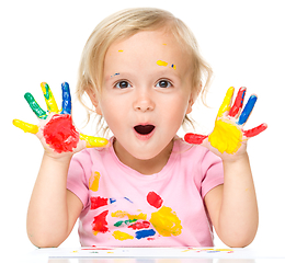 Image showing Portrait of a cute little girl playing with paints