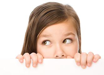 Image showing Little girl is looking from out blank board