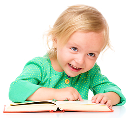 Image showing Little girl is reading her book