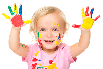 Image showing Portrait of a cute little girl playing with paints