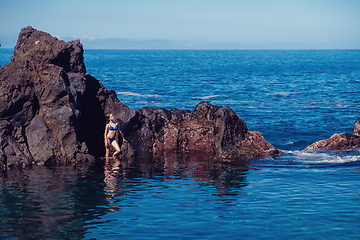 Image showing beautiful girl resting in natural ocean swimming pool