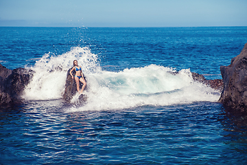 Image showing beautiful girl resting in natural ocean swimming pool