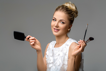 Image showing beautiful girl applying makeup