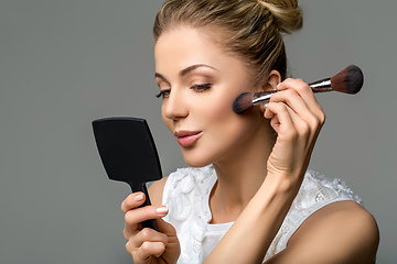 Image showing beautiful girl applying makeup