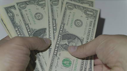 Image showing Man counting money of one thousand US dollars. UltraHD stock footage