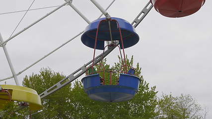 Image showing Underside view of a ferris wheel over blue sky.