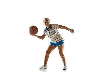 Image showing Senior woman playing basketball in sportwear on white background