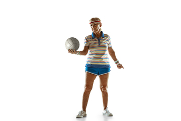 Image showing Senior woman playing volleyball in sportwear on white background