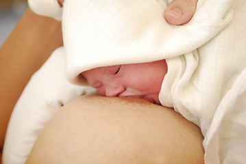 Image showing A breast-feeding