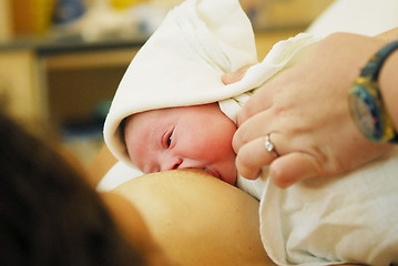 Image showing A breast-feeding