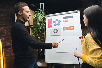 Image showing Colleagues working together in modern office using flipchart during creative meeting