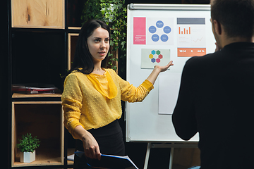 Image showing Colleagues working together in modern office using flipchart during creative meeting