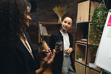 Image showing Colleagues, women talking together in modern office during coffee break