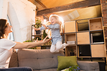 Image showing Family time. Mother and daughter having time together at home, look happy and sincere