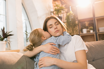 Image showing Family time. Mother and daughter having time together at home, look happy and sincere