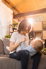 Image showing Family time. Mother and daughter having time together at home, look happy and sincere