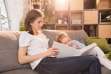 Image showing Family time. Mother and daughter having time together at home, look happy and sincere