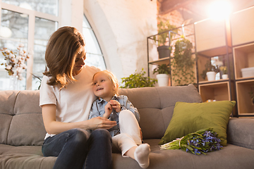 Image showing Family time. Mother and daughter having time together at home, look happy and sincere