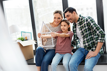 Image showing happy family with folding ruler moving to new home