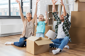 Image showing happy family playing with foam peanuts at new home