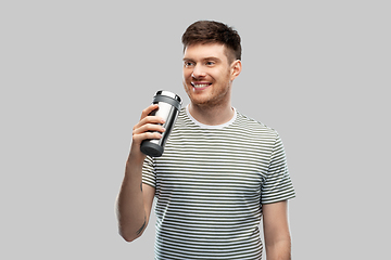 Image showing man with thermo cup or tumbler for hot drinks
