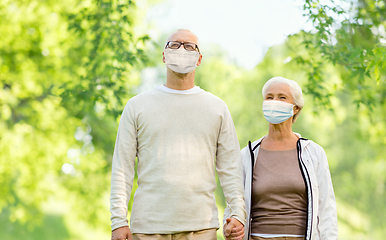 Image showing senior couple in protective medical masks outdoors