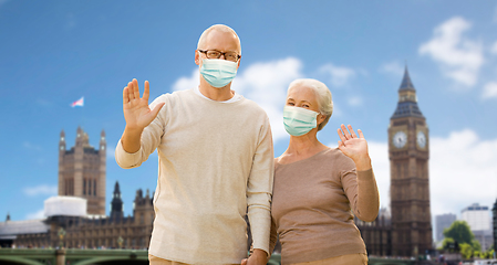 Image showing senior couple in medical masks in london