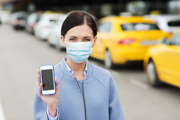 Image showing woman in face mask with smartphone in city