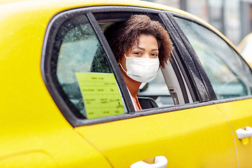 Image showing african american woman wearing face mask in taxi