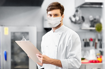 Image showing chef with clipboard in face mask at restaurant