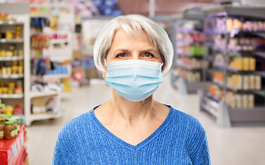 Image showing senior woman in medical mask at supermarket