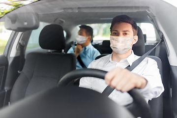 Image showing taxi driver in face protective mask driving car